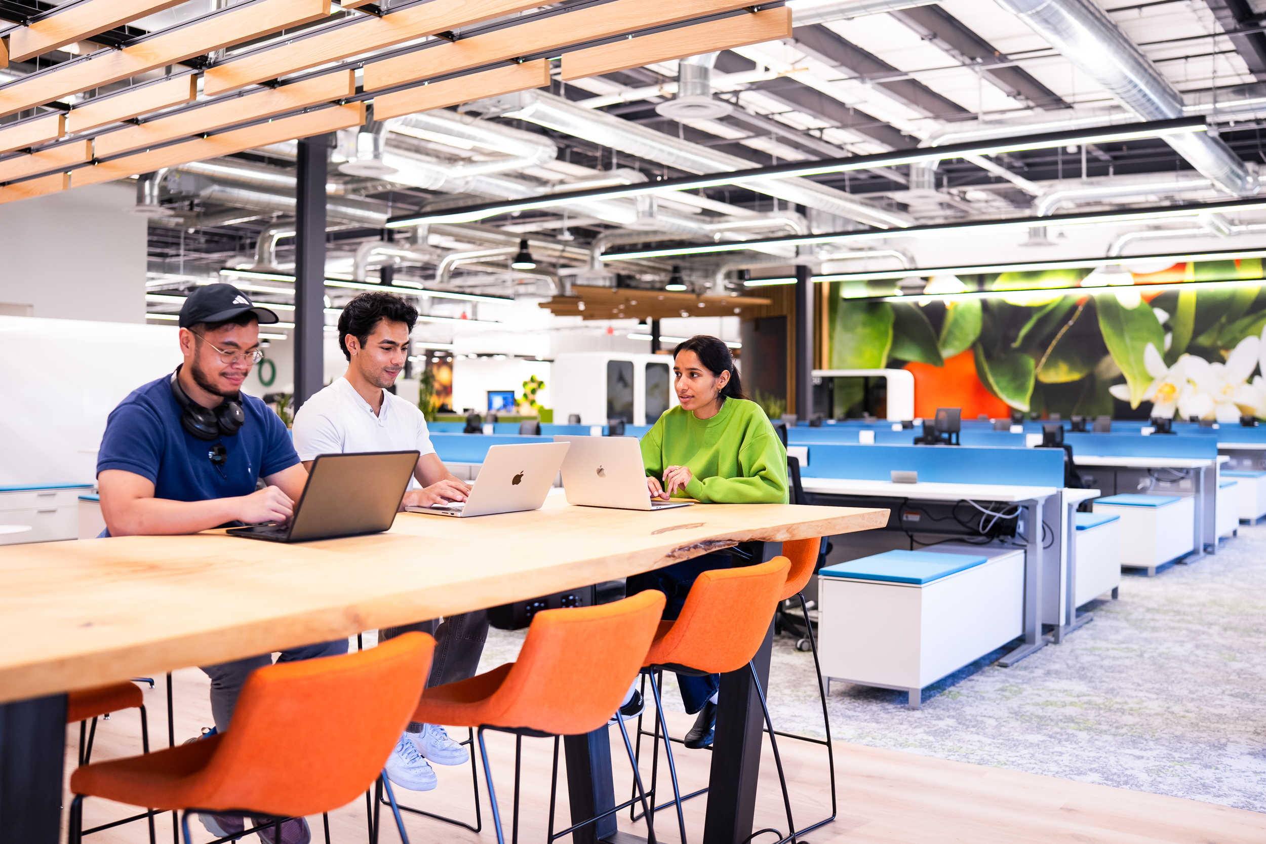 People sitting at a desk in an open office